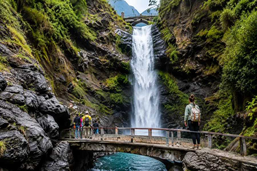 A stunning waterfall in Mindo surrounded by lush greenery.