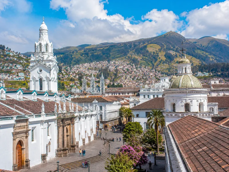View of Quito's Historic Center with churches and mountains.