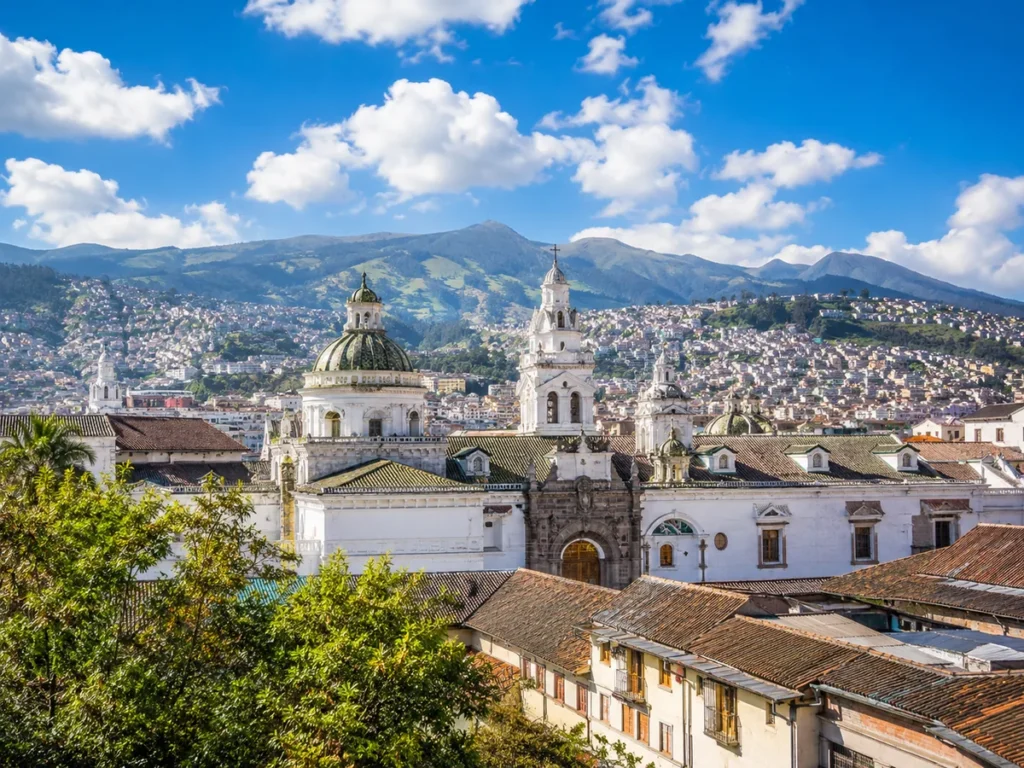 Scenic view of Quito's historic center with mountains.